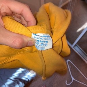 yellow medium sized authentic champion hoodie